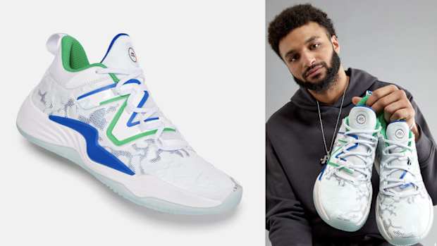 Jamal Murray holds up white New Balance shoes.